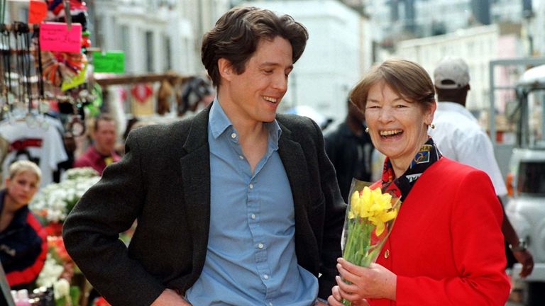 Actor Hugh Grant presents former actress Glenda Jackson, now Minister of Transport for London, during a visit to the set of his latest film on location in Notting Hill, west London today (Monday). Ms Jackson was on set to promote the possible role that a London Mayor could have in attracting more film makers to the capital. See PA story POLITICS Mayor. Photo by Fiona Hanson/PA