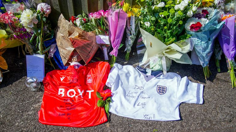 Flowers, messages and football shirts left at Magdala Road in Nottingham, where school caretaker Ian Coates  was found fatally stabbed. 