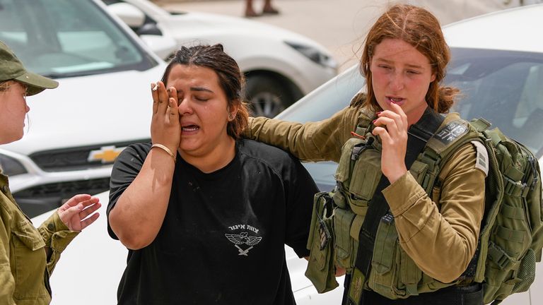 An Israeli soldier cries outside a military base following a deadly shootout in southern Israel along the Egyptian border, Saturday, June 3, 2023.  (AP Photo/Tsafrir Abayov)