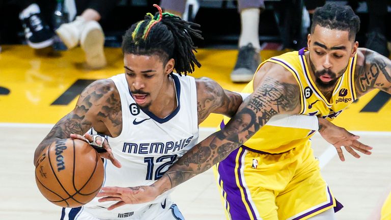 Memphis Grizzlies guard Ja Morant (12) and Los Angeles Lakers guard D&#39;Angelo Russell (1) vie for the ball during an NBA basketball playoffs round one game 6 Friday, April 28, 2023, in Los Angeles. (Ringo Chiu via AP)