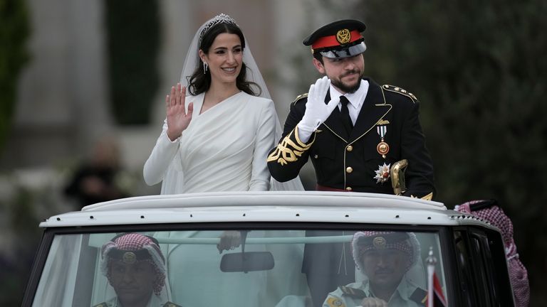 Jordan&#39;s Crown Prince Hussein and Saudi Rajwa Alseif wave to well-wishers. Pic: AP