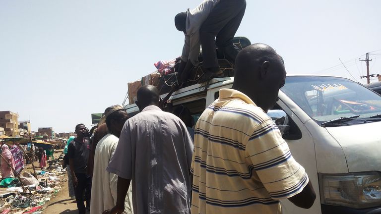 People board a bus to leave Khartoum, Sudan (AP Photo)