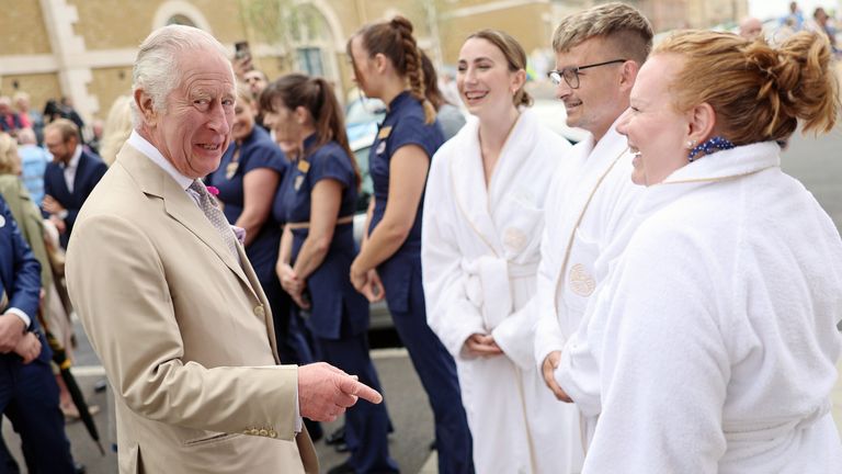 King Charles III meets employees and clients of the spa during a visit to the Duchy of Cornwall&#39;s Poundbury development in Dorset, to view new bronze reliefs by artist Ian Rank-Broadley, mark the completion of Queen Mother Square, and open the Duke of Edinburgh Garden which forms part of Pavilion Green. Picture date: Tuesday June 27, 2023.