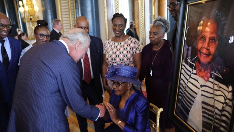 EMBARGOED TO 0001 THURSDAY JUNE 22 Previously unissued photo dated 14/06/23 of King Charles III shakes hands with Gilda Oliver (seated) during a reception at Buckingham Palace in London, to mark the 75th anniversary of the arrival of HMT Empire Windrush to Tilbury Docks in Essex, on June 22 1948. Issue date: Thursday June 22, 2023.