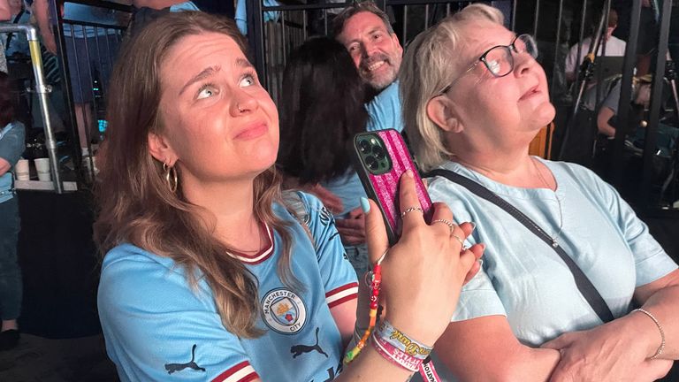 Sam and her mum watching the match