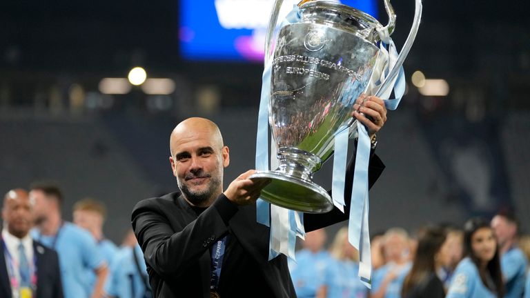 Pep Guardiola holds the trophy after winning the final. Pic: AP
