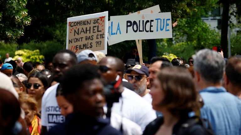 People attend a march in tribute to Nahel, a 17-year-old teenager killed by a French police officer during a traffic stop, in Nanterre, Paris suburb, France, June 29, 2023. The slogans read "Police kill" and "How many Nahel were not filmed ?". REUTERS/Sarah Meyssonnier

