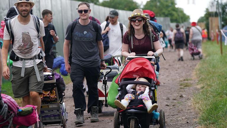 Festivalgoers Justin (blue top) and Amy Martindale from Southsea in Portsmouth (centre), and their two year old daughter Alice, on the first day of the Glastonbury Festival at Worthy Farm in Somerset. Picture date: Wednesday June 21, 2023.

