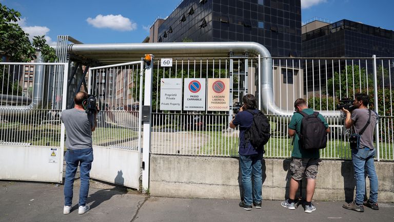 Members of the media work outside San Raffaele hospital where former Italian Prime Minister Silvio Berlusconi died