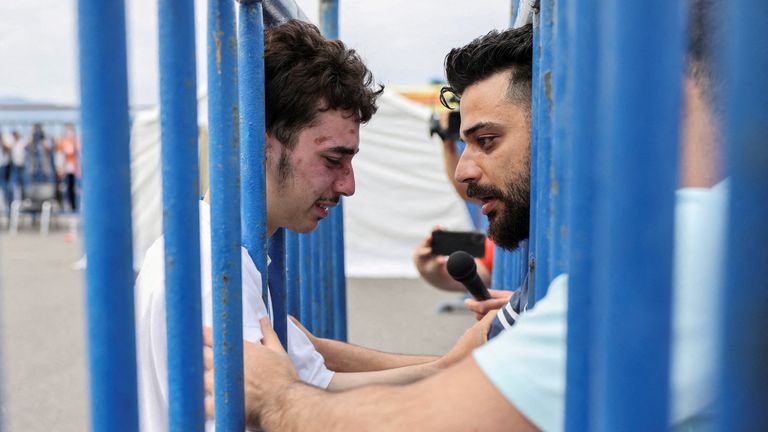Syrian survivor Mohammad, 18, who was rescued with other refugees and migrants at open sea off Greece after their boat capsized, cries as he reunites with his brother Fadi, who came to meet him from Netherlands, at the port of Kalamata, Greece, June 16, 2023. REUTERS/Stelios Misinas REFILE - CORRECTING IDs
