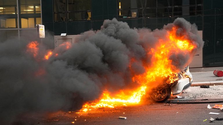 A car burns after a march for Nahel, Thursday, June 29, 2023 in Nanterre, outside Paris. The killing of 17-year-old Nahel during a traffic check Tuesday, captured on video, shocked the country and stirred up long-simmering tensions between young people and police in housing projects and other disadvantaged neighborhoods around France. (AP Photo/Michel Euler)