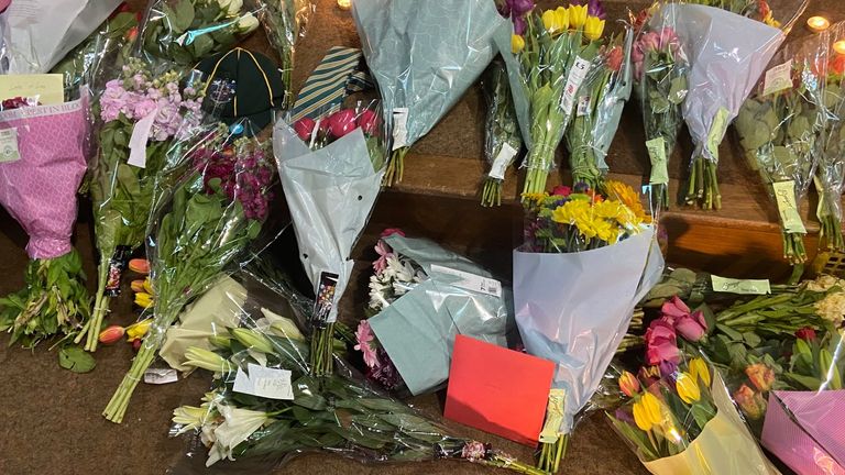Flowers were left at a vigil at St Peter's Church with a card reading 'Grace'