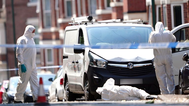 Police forensics officers search a white van on the corner of Maples Street and Bentinck Road in Nottingham