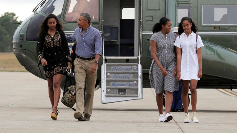 Malia (right) and Sasha Obama board Air Force One with their parents in 2016