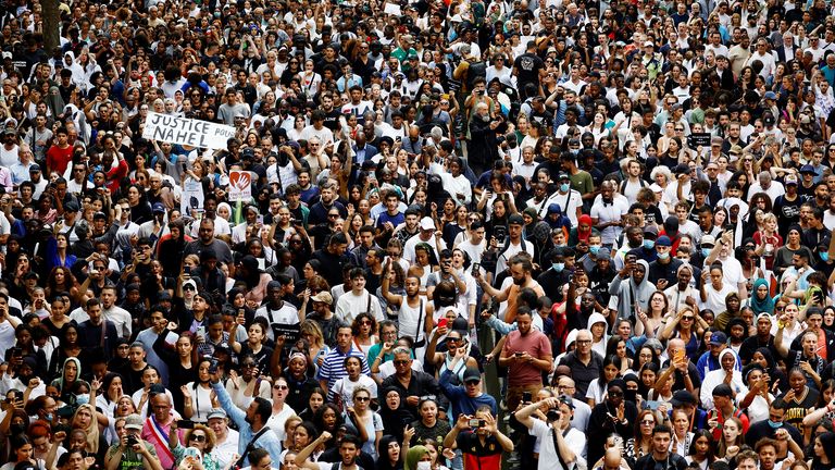 People attend a march in tribute to Nahel, a 17-year-old teenager killed by a French police officer during a traffic stop, in Nanterre, Paris suburb, France, June 29, 2023. The slogan reads "Justice for Nahel".  REUTERS/Sarah Meyssonnier