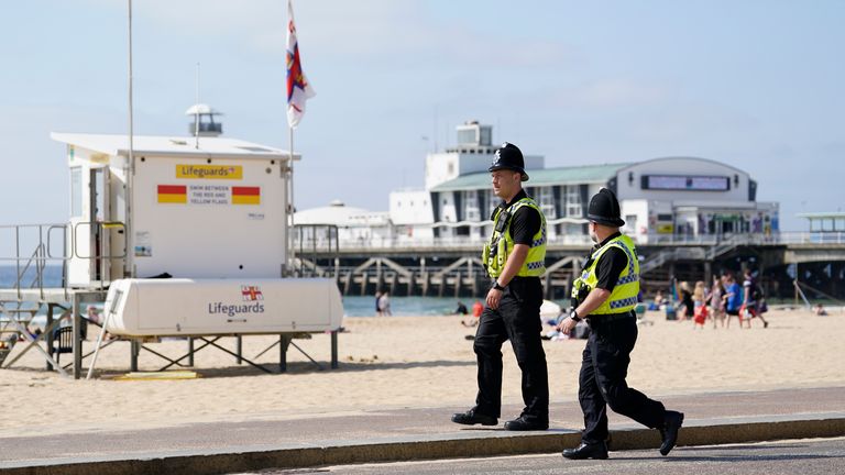 Police officers walk along Bournemouth beach after a 17-year-old-boy and a girl aged 12 sustained "critical injuries" on Wednesday, and later died in hospital. A man in his 40s has been arrested on suspicion of manslaughter following the incident. Picture date: Thursday June 1, 2023.