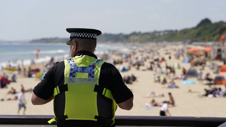 A police officer looks out over Bournemouth beach, after a 17-year-old-boy and a girl aged 12 sustained "critical injuries" on Wednesday, and later died in hospital following an incident off the beach. Picture date: Friday June 2, 2023.