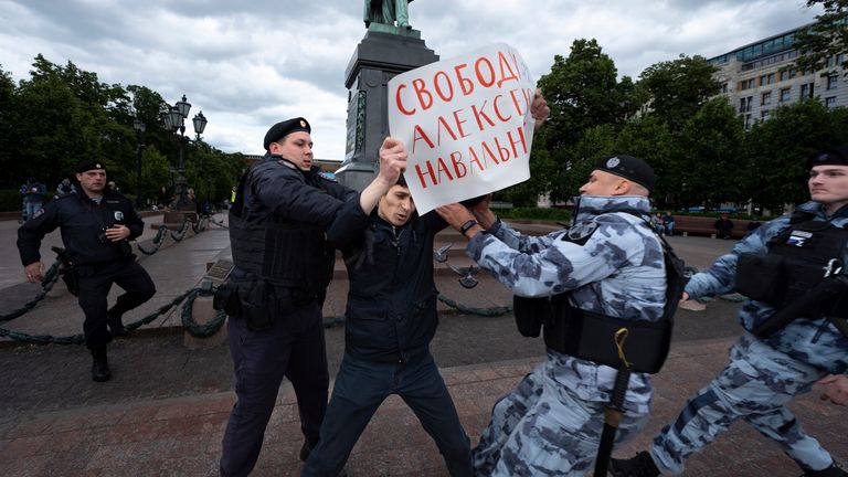 Police officers detain a demonstrator with a poster that reads: "Freedom for Alexei Navalny", in Pushkinskaya Square in Moscow, Russia, Sunday, June 4, 2023. Imprisoned opposition leader Alexei Navalny has voiced hope for a better future in Russia as his supporters held demonstrations to mark his birthday. Risking their own prison terms, some Navalny supporters in Russia marked his birthday by holding individual pickets, and other painted graffiti. Police quickly detained many for questioning. (