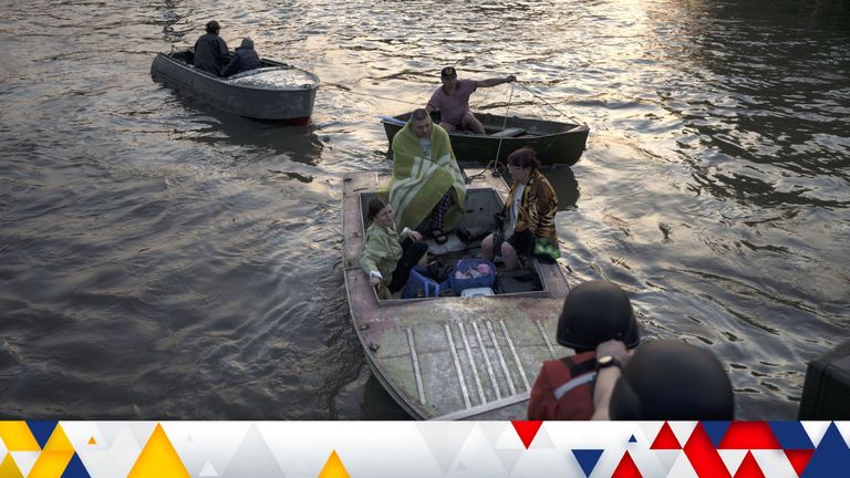 Tow boats carrying residents being evacuated from a flooded neighbourhood in Kherson / AP