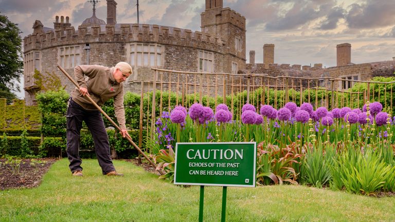 Undated handout photo issued by English Heritage of a person at Walmer Castle, gardening behind a Ministry of Works style signs encouraging the use of senses at English Heritage sites. Issue date: Friday June 9, 2023.