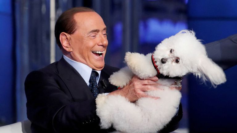 Italy&#39;s former Prime Minister Silvio Berlusconi plays with a dog during the television talk show "Porta a Porta" (Door to Door) in Rome, Italy June 21, 2017. 