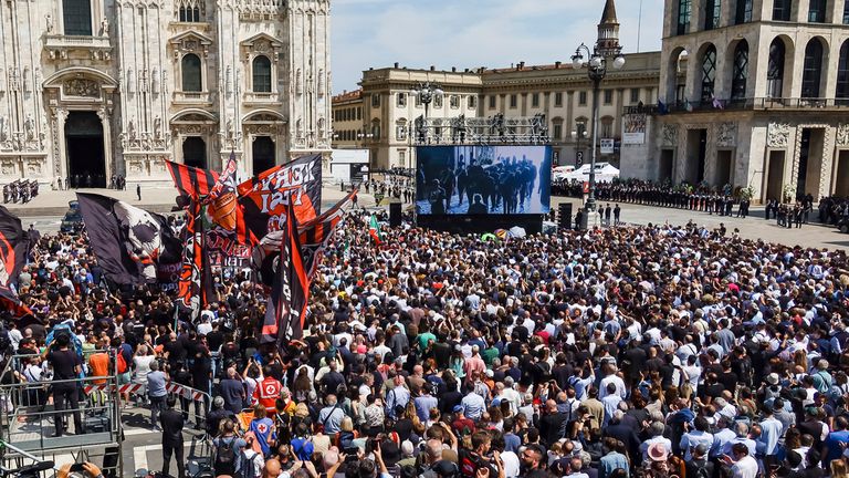 Crowds watched the state funeral on a giant screen in Milan Pic: AP 