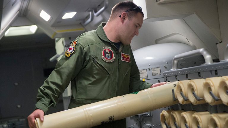 Naval Aircrewman 2nd Class Karl Shinn unloads a Sonobuoy from a rack onboard a P-8A Poseidon during a search mission to locate Malaysia Airlines flight MH370 in the Indian Ocean, in this U.S. Navy handout photo taken April 10, 2014. Search and rescue officials in Australia are confident they know the approximate position of the black box recorders from missing Malaysia Airlines Flight MH370, Australian Prime Minister Tony Abbott said on Friday. Picture taken April 10, 2014. REUTERS/U.S. Navy/Chi