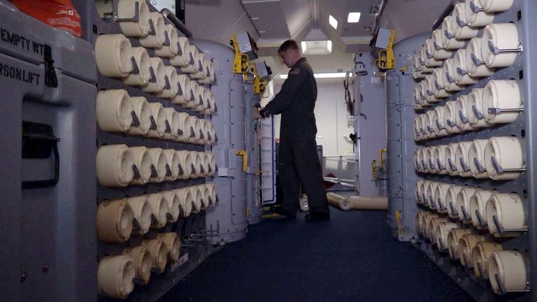 A member of the U.S. Navy, aboard the Boeing P-8A Poseidon plane, places a sonobuoy in the launching compartment to drop it at sea as they fly over the South Atlantic Ocean during the search for the ARA San Juan submarine missing at sea, Argentina November 22, 2017. A sonobuoy is an expendable sonar system that is ejected from aircraft or ships conducting anti-submarine warfare or underwater acoustic research. Picture taken November 22, 2017. REUTERS/Magali Cervantes