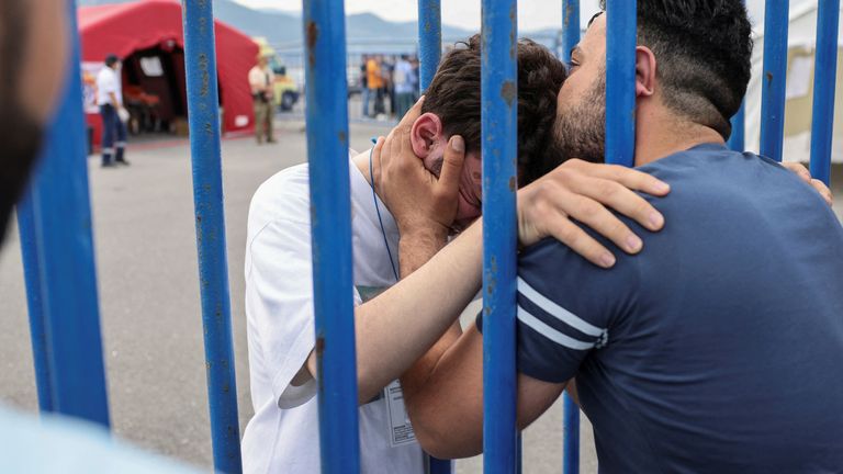 Syrian survivor Mohammad, 18, who was rescued with other refugees and migrants at open sea off Greece after their boat capsized, cries as he reunites with his brother Fadi, who came to meet him from Netherlands, at the port of Kalamata, Greece