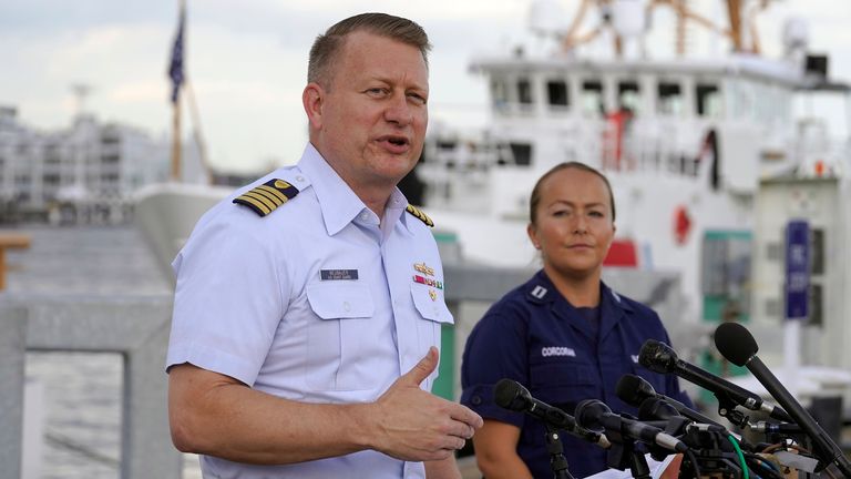 Capt. Jason Neubauer, chief investigator, U.S. Coast, left, speaks with the media as Samantha Corcoran, public affairs officer of the First Coast Guard District, right, looks on during a news conference, Sunday, June 25, 2023, at Coast Guard Base Boston, in Boston. The U.S. Coast Guard said it is leading an investigation into the loss of the Titan submersible that was carrying five people to the Titanic, to determine what caused it to implode. (AP Photo/Steven Senne)