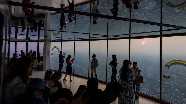 People take pictures of smoky Toronto from the CN Tower as wildfires continue to burn in Ontario and Quebec.  June 6, 2023, Toronto, Ontario, Canada.Reuters/Carlos Osorio