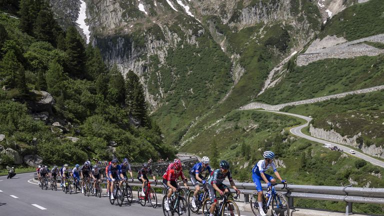The pack climbs the Furka pass during the fifth stage, a 211 km race from Fiesch to La Punt, of the 86th Tour de Suisse UCI World Tour cycling race in Goms, Switzerland, Thursday, June 15, 2023. (Gian Ehrenzeller/Keystone via AP)
