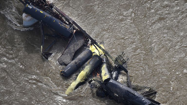 Portions of a freight train are seen in the Yellowstone River after an overnight railroad bridge collapse, near Columbus, Mont., Saturday, June 24, 2023. (Larry Mayer/The Billings Gazette via AP)