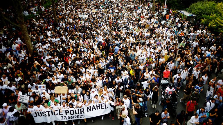 People attend a march in tribute to Nahel, a 17-year-old teenager killed by a French police officer during a traffic stop, in Nanterre, Paris suburb, France, June 29, 2023. The slogan reads "Justice for Nahel".  REUTERS/Sarah Meyssonnier