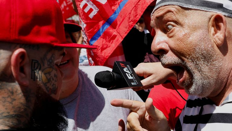 A supporter of former U.S. President Donald Trump and an anti-Trump demonstrator argue near the Wilkie D. Ferguson Jr. United States Courthouse, on the day former U.S. President Donald Trump is to appear at his arraignment on classified document charges, in Miami, Florida, U.S., June 13, 2023. REUTERS/Marco Bello