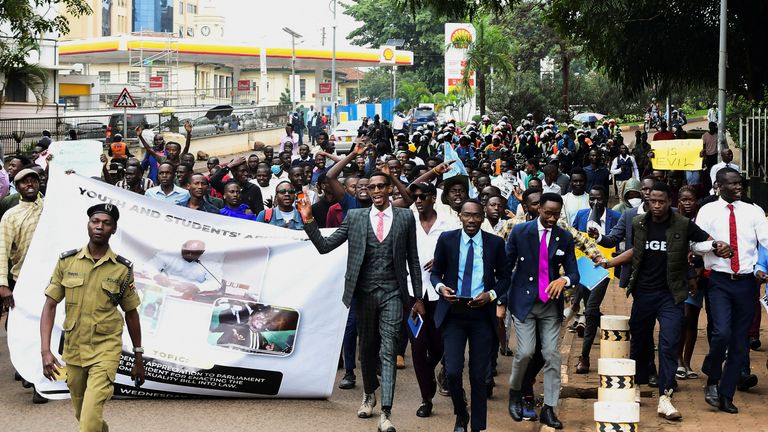 Ugandan students take part in a walk to show their support for the passing of the  LGBTQ+  bill