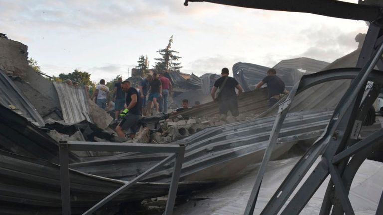 People clear the rubble on the roof of the restaurant. Pic: National Police of Ukraine via AP