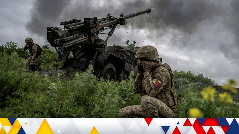 Ukrainian service members fire a Caesar self-propelled howitzer towards Russian troops