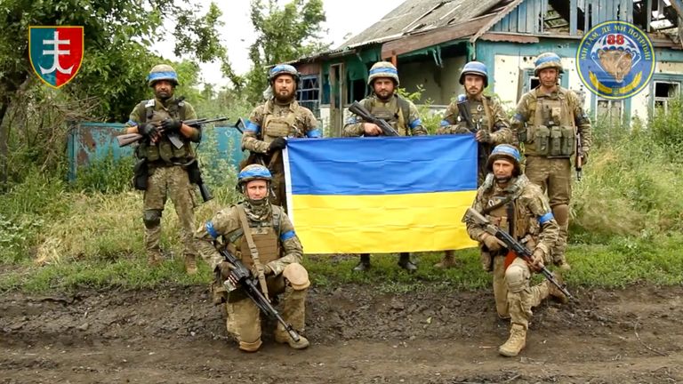 Ukrainian servicemen of the 35th Separate Brigade of Marines pose for a photograph with the Ukrainian flag in the liberated village of Storozheve, in Dontesk region, Ukraine, in the still image taken from a social media video released on June 12, 2023. 35th Separate Brigade of Marines via Facebook/via REUTERS THIS IMAGE HAS BEEN SUPPLIED BY A THIRD PARTY
