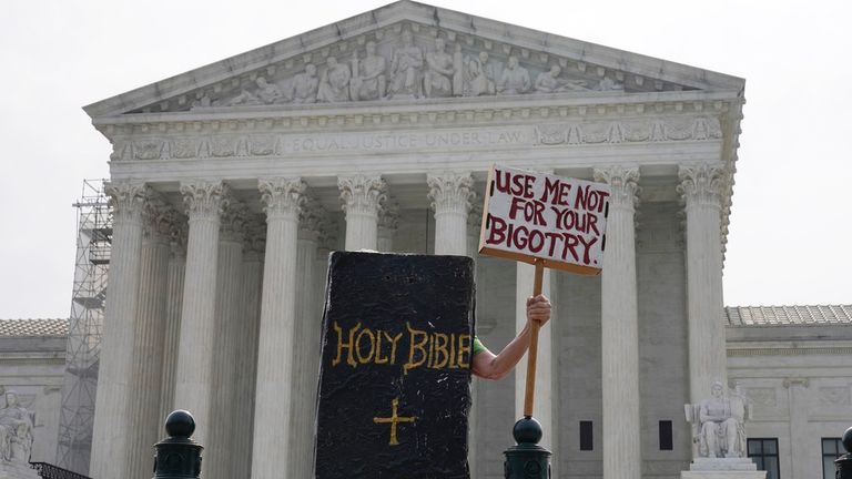 A protester seen outside the Supreme Court on Friday ahead of the ruling Pic: AP 