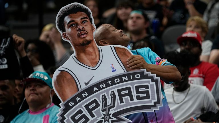 A fan holds a photo of Victor Wembanyama during the San Antonio Spurs&#39; NBA basketball draft party at AT&T Center in San Antonio. Pic: AP