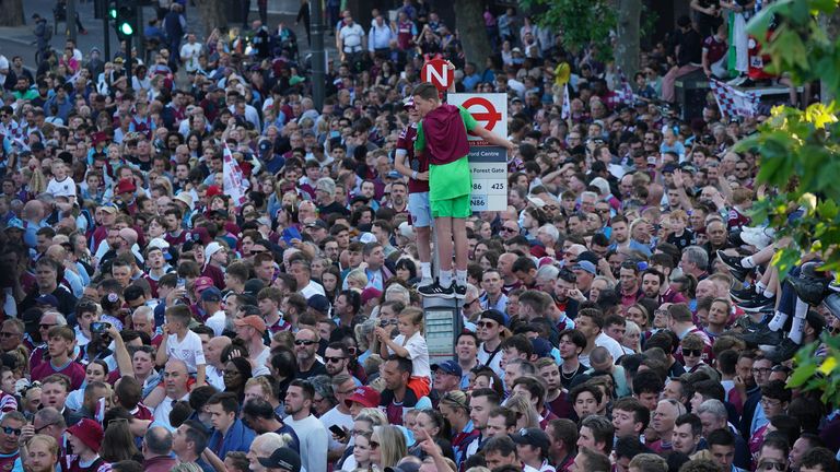 Fans climbed to the top of bus stops and traffic lights to get a good view of the bus 