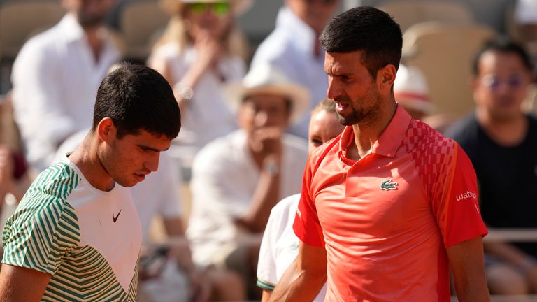 Serbia&#39;s Novak Djokovic, right, accompanies Spain&#39;s Carlos Alcaraz after he got leg cramps during their semifinal match of the French Open tennis tournament at the Roland Garros stadium in Paris, Friday, June 9, 2023. (AP Photo/Thibault Camus)