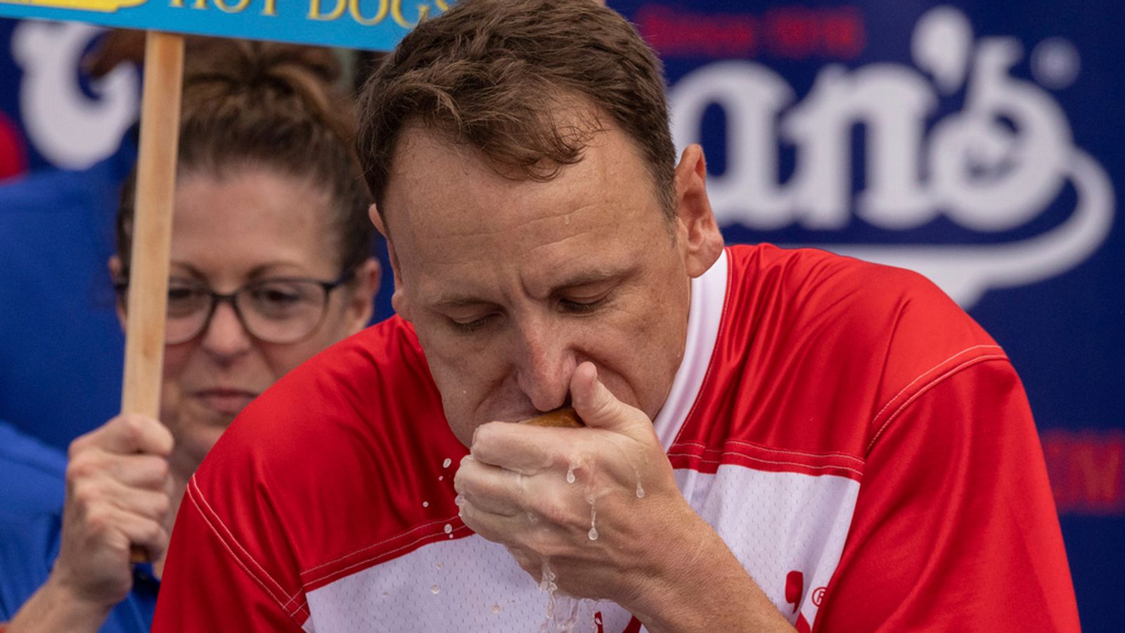 Man downs 62 sizzling canines in 10 minutes to defend well-known Fourth of July contest belt