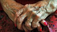 Hands of an elderly woman at home