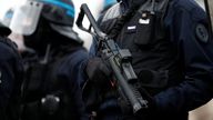 A French police officer in riot gear holds a flashball gun as protesters wearing yellow vests take part in a demonstration by the "yellow vests" movement at Place de la Bastille in Paris, France January 26, 2019. REUTERS/Benoit Tessier
