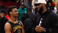 Bronny James speaking to his dad at a games in March
