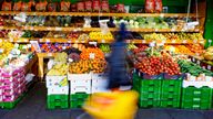 A customer passes a fruit supermarket in London, Wednesday, Nov. 17, 2021 