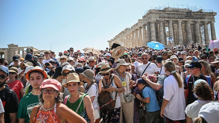 A large crowd of tourists visit the Parthenon Temple on the Acropolis Hill on this hot day
Pic:AP