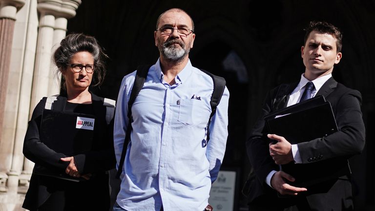 Andrew Malkinson (centre) arrives at the Royal Courts of Justice in London, ahead of his hearing at the Court of Appeal over his 2003 rape conviction. Mr Malkinson was convicted of attacking a woman in Greater Manchester in 2003 and jailed for life the following year, but challenged his conviction in light of new DNA evidence linking another potential suspect to the crime. Picture date: Wednesday July 26, 2023.